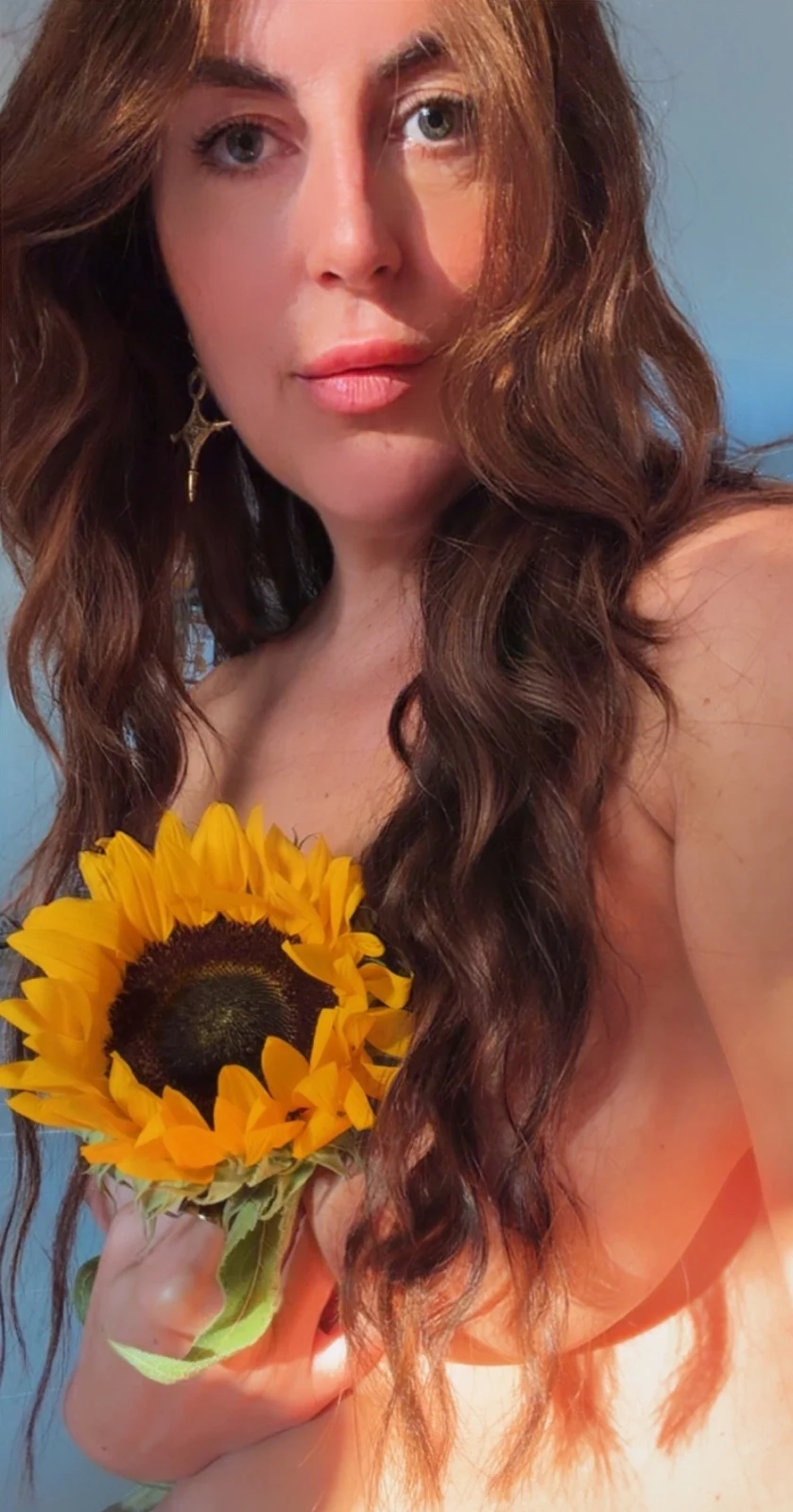 Portrait of Ava holding a sunflower